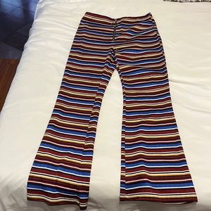 Stretchy cropped flare knot pants. Zipper front.